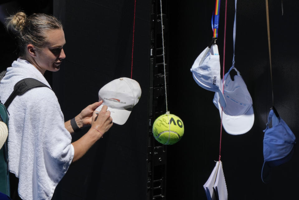 Arena Sabalenka of Belarus signs autographs following a practice session ahead of the Australian Open tennis championships at Melbourne Park, Melbourne, Australia, Friday, Jan. 12, 2024. (AP Photo/Andy Wong)