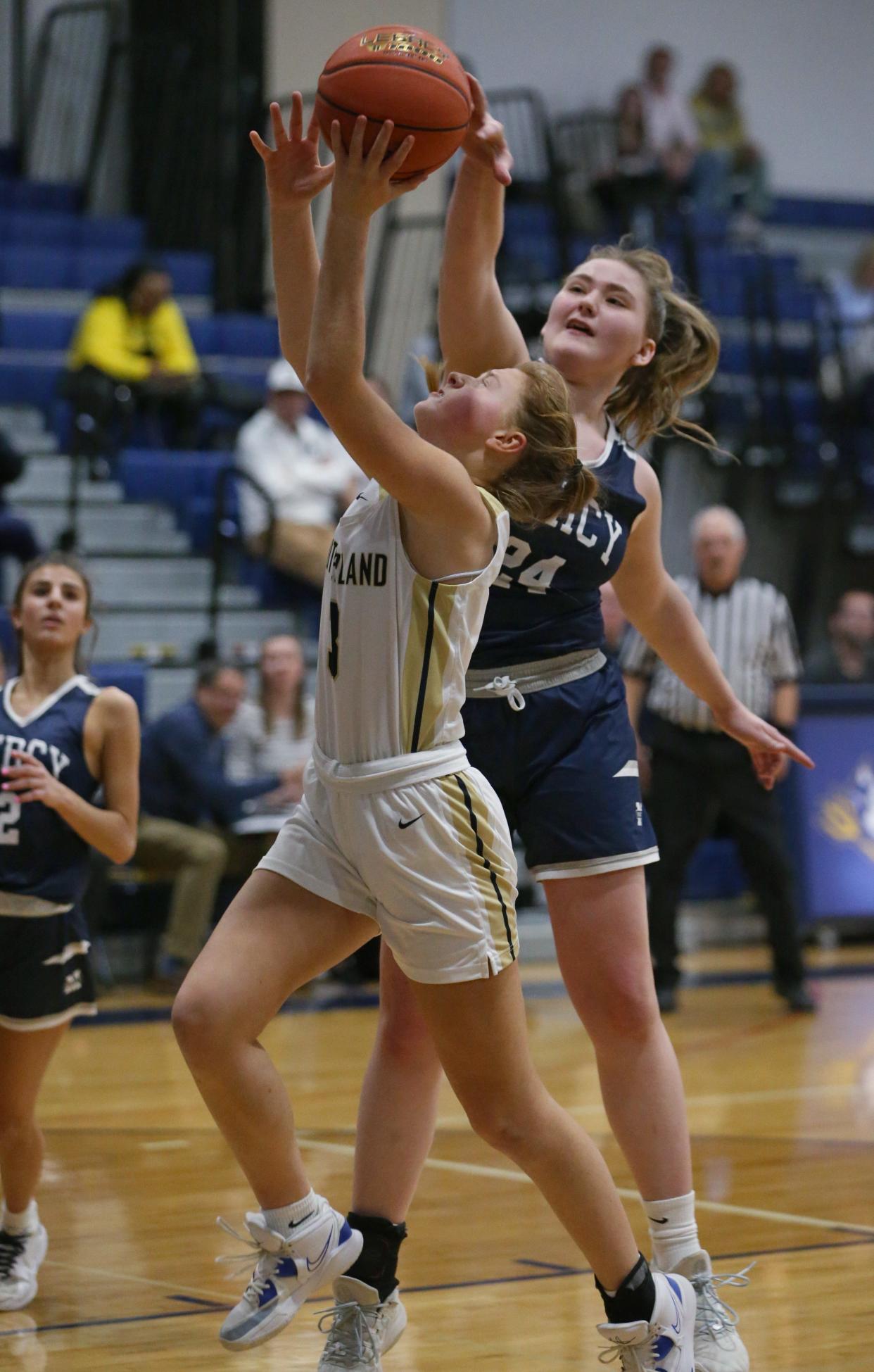 Pittsford Sutherland's Leora Cook goes for a layup while Mercy's Audrey Hintz defends.