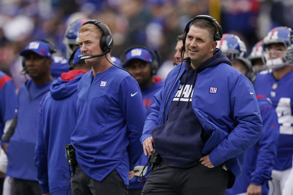 New York Giants head coach Joe Judge, right, and offensive coordinator Jason Garrett, left, react during the first half of an NFL football game against the Carolina Panthers, Sunday, Oct. 24, 2021, in East Rutherford, N.J. (AP Photo/Seth Wenig)