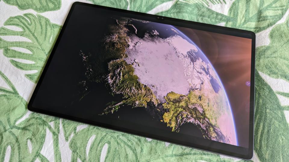 Samsung Galaxy Tab S9 Ultra 5G on leafy bedsheets  displaying picture of the world