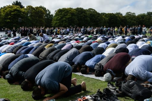 Muslim men pray in a park near the Al Noor mosque, shortly after a two minutes silence held in memory of the victims of last Friday's shooting