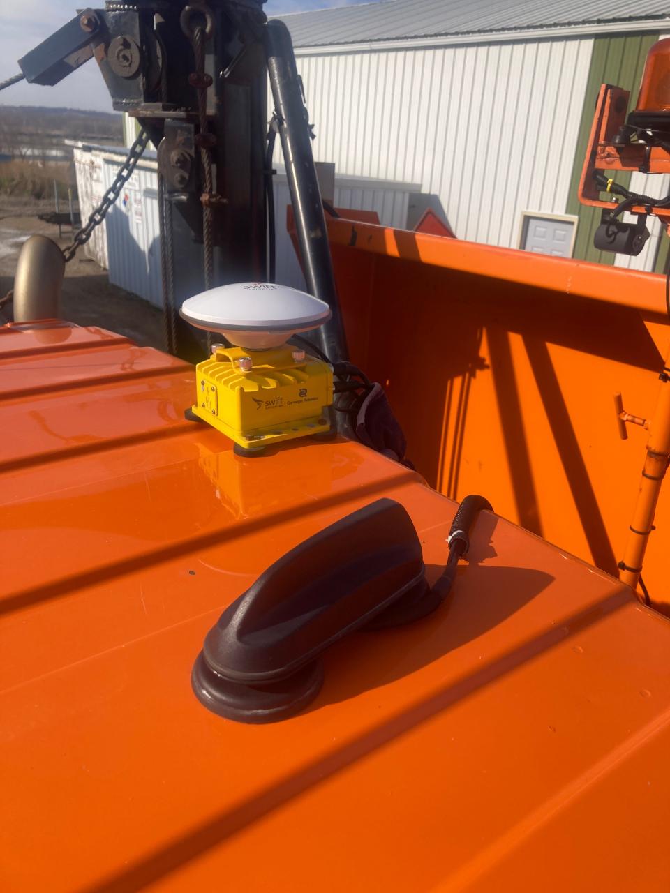 A GPS unit is attached to a snowplow truck in Tama. Lane guidance used in snowplows would rely on highly accurate maps of roadways and GPS technology to track the vehicle's location.