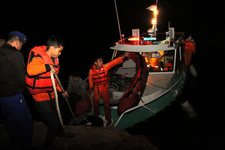 Search and rescue workers are seen on a boat used in the search for passengers from the Sinar Bangun ferry that sank in Lake Toba in Simalungun, North Sumatra, Indonesia June 19, 2018 in this photo taken by Antara Foto. Antara Foto/Lazuardy Fahmi/ via REUTERS