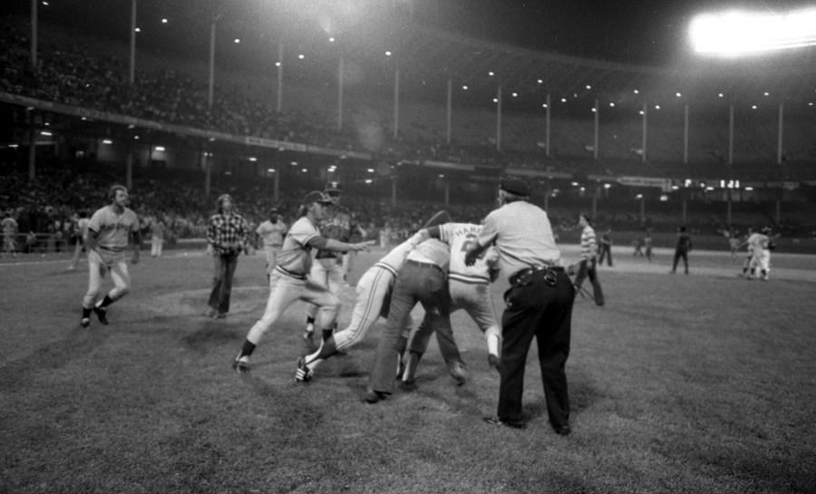 CLEVELAND, OH – JUNE 4,1974: Members of the Texas Rangers take down a drunken fan who ran onto the field during a game against the Cleveland Indians on June 4, 1974 at Cleveland Municipal Stadium in Cleveland, Ohio. Texas was awarded a win by forfeit 5-5 when the game was called by the umpires, due to fans storming the field during 10 cent beer night. (Photo by: Paul Tepley Collection/Diamond Images/Getty Images)