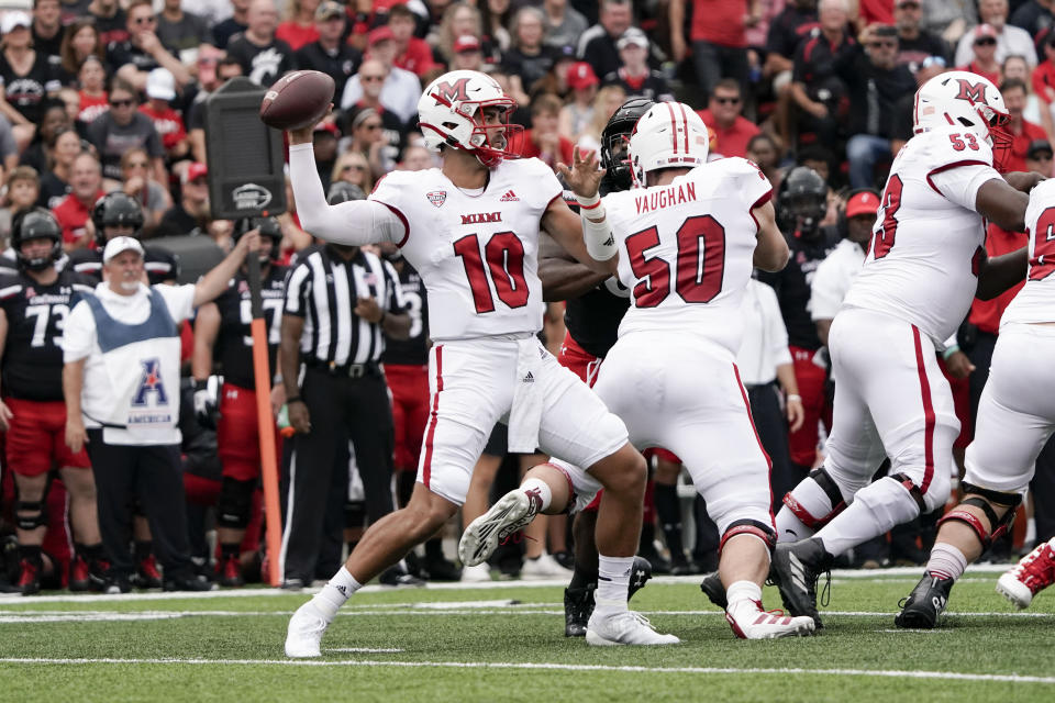 Miami (Ohio) quarterback AJ Mayer (10) throws during the first half of an NCAA college football game against Cincinnati, Saturday, Sept. 4, 2021, in Cincinnati. (AP Photo/Jeff Dean)