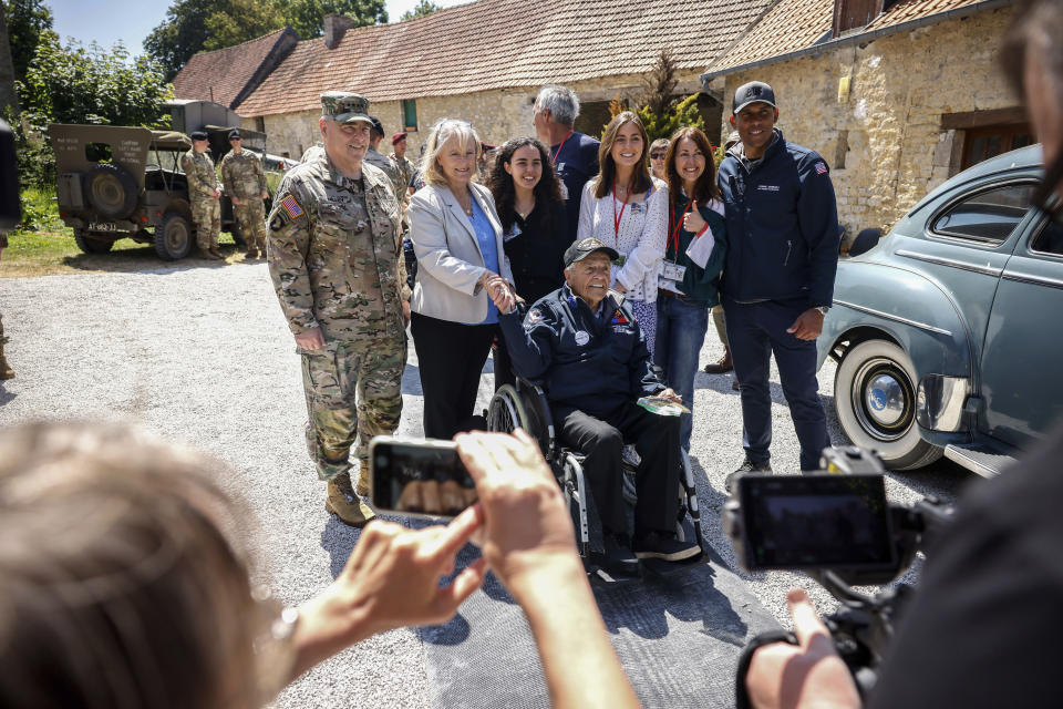U.S. Gen. Mark Milley, left, his wife Hollyanne Milley, 2nd left, veteran Sgt. Andrew Negra, center on wheel chair, and his family pose for a group photo during a gathering in preparation of the 79th D-Day anniversary in La Fiere, Normandy, France, Sunday, June 4, 2023. The landings on the coast of Normandy 79 year ago by U.S. and British troops took place on June 6, 1944. (AP Photo/Thomas Padilla)