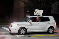 A driver holds a sign out their window as they drive by Boeing workers picketing after union members voted overwhelmingly to reject a contract offer and go on strike Friday, Sept. 13, 2024, outside the company's factory in Renton, Wash. (AP Photo/Lindsey Wasson)