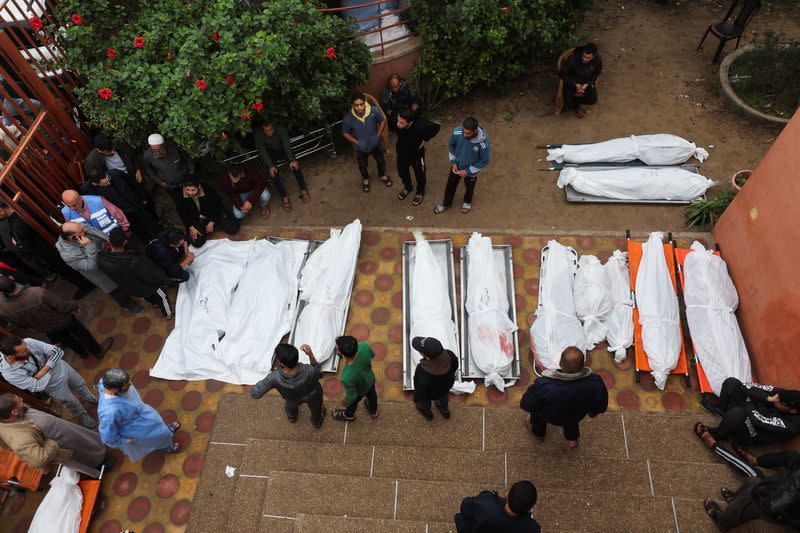 Bodies of Palestinians who were killed during Israeli strikes are laid out at Nasser hospital
