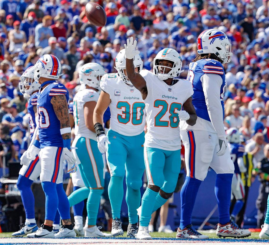 Miami Dolphins running back De’Von Achane (28) tosses the ball towards the stands after scoring against the Buffalo Bills at Highmark Stadium in Orchard Park, NY., on Sunday, October 1, 2023. Al Diaz/adiaz@miamiherald.com