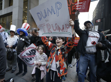 Two children joins the march at a protest against Donald Trump in midtown Manhattan in New York City, April 14, 2016. REUTERS/Mike Segar