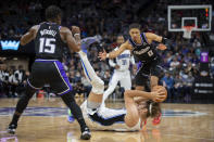 Orlando Magic center Robin Lopez (33) comes down with a loose ball between Sacramento Kings guard Tyrese Haliburton (0) and guard Davion Mitchell (15) during the second half of an NBA basketball game in Sacramento, Calif., Wednesday, Dec. 8, 2021. (AP Photo/Jose Luis villegas)