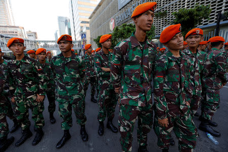 Indonesian soldiers stand guard during a protest in front of the Election Supervisory Agency (Bawaslu) headquarters following the announcement of the last month's presidential election results in Jakarta, Indonesia, May 22, 2019. REUTERS/Willy Kurniawan