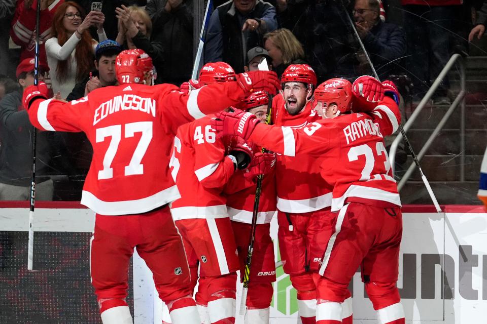 Detroit Red Wings center Dylan Larkin, second from right, celebrates his goal against the New York Islanders in the second period of an NHL hockey game Thursday, March 21, 2024, in Detroit. (AP Photo/Paul Sancya)