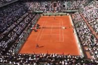 French Jo-Wilfried Tsonga (down) hits a return to Russia's Andrey Kuznetsov during their Men's Singles 1st Round tennis match of the French Open tennis tournament at the Roland Garros stadium, in Paris. Tsonga struggled under the weight of expectations while dangerman Juan Martin Del Potro shrugged off an injury scare on Sunday's sweltering opening day at Roland Garros