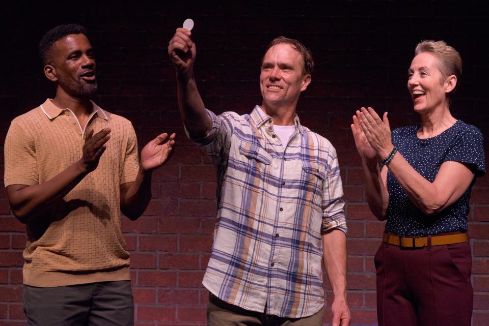 Saxon Palmer, center, plays a theater director working on recovery from alcoholism, with Michael Flood, left, and Julia Brothers, in Sean Daniels’ “The White Chip” at Florida Studio Theatre.
