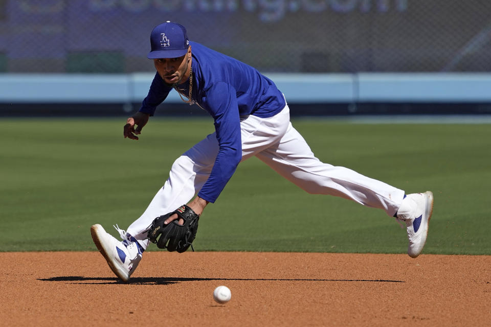 Los Angeles Dodgers' Mookie Betts fields a ball during practice ahead of the NLDS Friday, Oct. 6, 2023, in Los Angeles. (AP Photo/Mark J. Terrill)