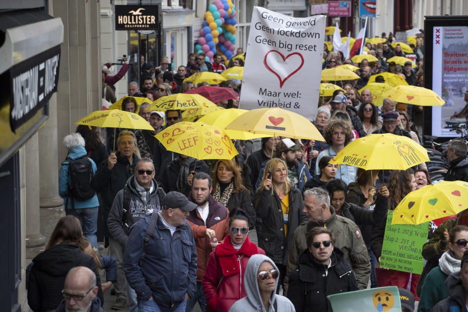 A banner reads "No Violence, No Lockdown, No Big Reset, but Freedom and Love" during a demonstration against coronavirus related restrictions in Amsterdam, Netherlands, Sunday, May 2, 2021. (AP Photo/Peter Dejong)