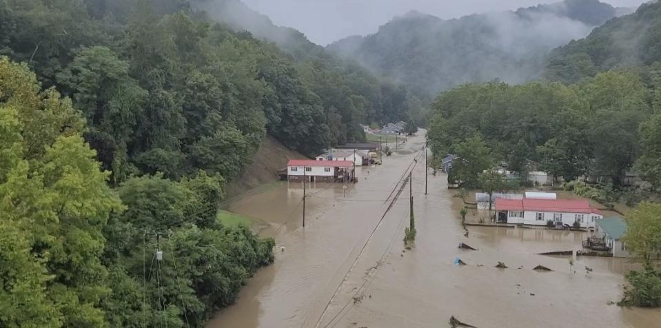 Floodwaters cover a road along a narrow valley following severe thunderstorms Monday, Aug. 28, 2023, in Chesapeake, W.V. (Bob Aaron/WCHS-TV via AP)