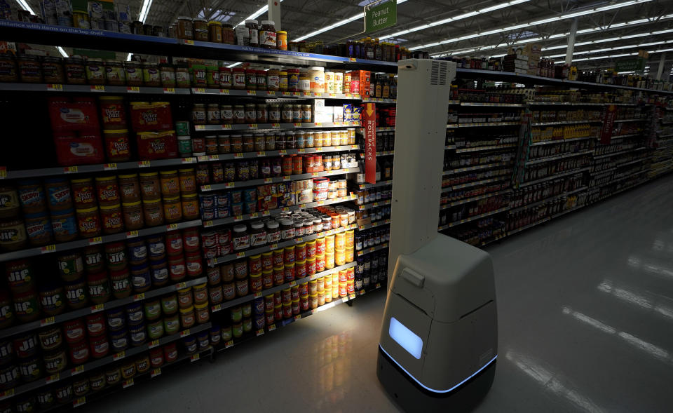 FILE - In this Nov. 9, 2018, file photo, a Bossa Nova robot scans shelves to help provide associates with real-time inventory data at a Walmart Supercenter in Houston. Robots aren’t replacing everyone, but a quarter of U.S. jobs will be severely disrupted as artificial intelligence accelerates the automation of today’s work, according to a new Brookings Institution report. The report published Thursday, Jan. 24, 2019, says roughly 36 million Americans hold jobs with “high exposure” to automation, meaning about 70 percent of their work tasks could soon be performed by machines using current technology. (AP Photo/David J. Phillip, File)