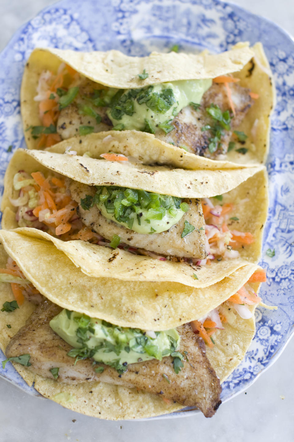 This June 3, 2013 photo taken in Concord, N.H. shows a recipe for healthy fish tacos with avocado. (AP Photo/Matthew Mead)