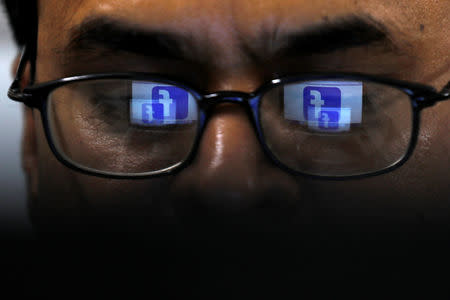 Facebook logo is reflected in glasses in this picture illustration taken April 1, 2019. REUTERS/Akhtar Soomro/Illustration