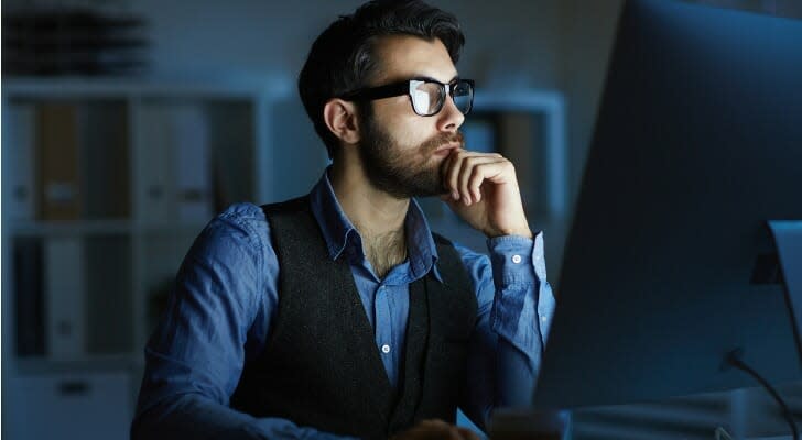 A man looks over his investment portfolio. Deutsche Bank writes that the stock market could see a return to value investing as interest rates rise.