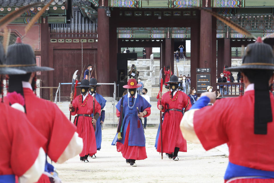 Imperial guards wearing face masks to help protect against the spread of the coronavirus move the Gyeongbok Palace in Seoul, South Korea, Sunday, Sept. 13, 2020. (AP Photo/Ahn Young-joon)