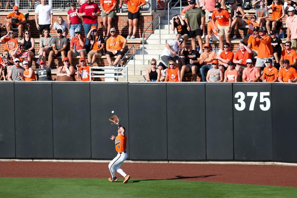 Oklahoma St. utility Zach Ehrhard (4) catches a fly ball in the outfield during a NCAA Regional baseball championship game between Oklahoma St. and Arkansas at O'Brate Stadium in Stillwater, Okla. on Monday, June 6, 2022.(Ian Maule/Tulsa World via AP)