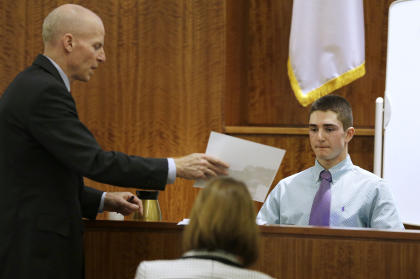 William McCauley, left, shows a witness a photograph. (AP)