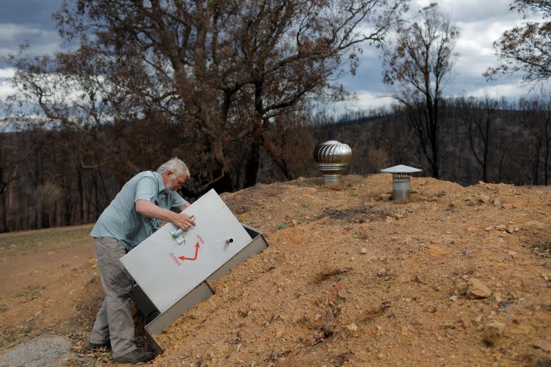 Donald Graham, 68, displays his bunker that he and his wife Bron took shelter in as their home was destroyed by bushfire in Buchan, Victoria, Australia