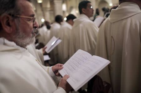 Clergymen attend a Christmas midnight mass led by Latin Patriarch of Jerusalem Fouad Twal at the Church of the Nativity in the West Bank town of Bethlehem December 25, 2015. REUTERS/Fadi Arouri/Pool