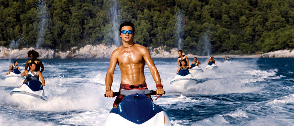 Dominic Cooper riding a jetski.