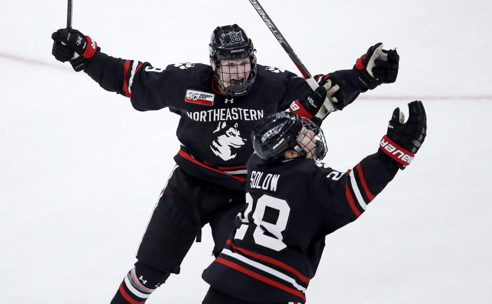 Northeastern forward Zach Solow, right, celebrates his goal against Boston College with forward Lincoln Griffin, rear left, during the third period of the NCAA hockey Beanpot tournament championship game in Boston, Monday, Feb. 11, 2019. Northeastern won 4-2. (AP Photo/Charles Krupa)