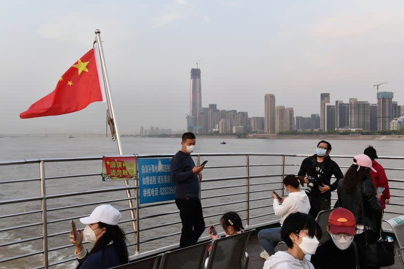 Passengers wearing face masks ride a ferry on Yangtze River in Wuhan