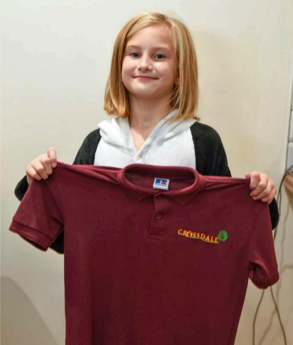 9-year-old Lily wears a onesie to school after becoming allergic to her uniform. (Photo: Caters)