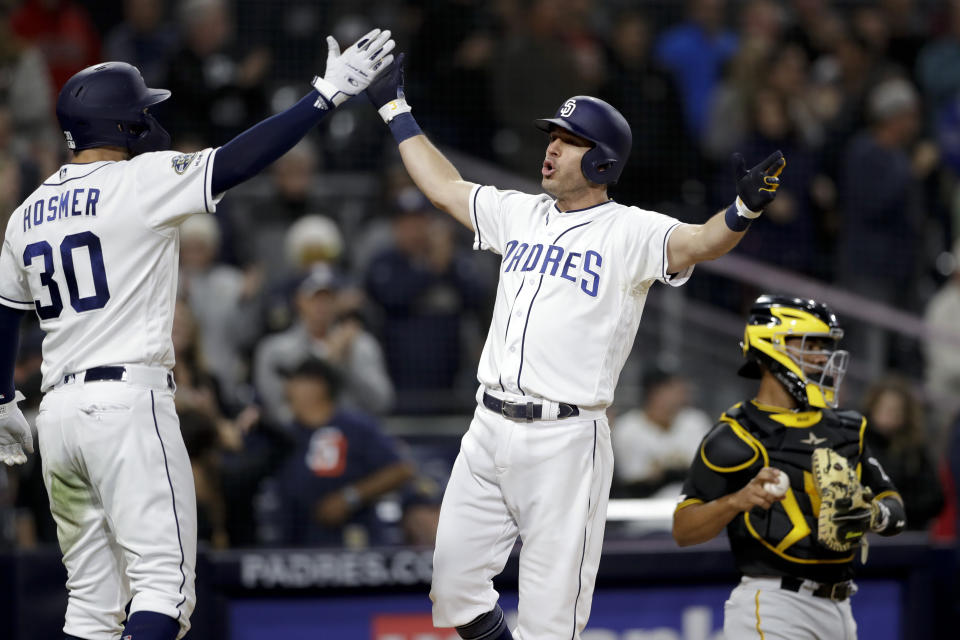 San Diego Padres' Ian Kinsler, center, celebrates with teammate Eric Hosmer (30) after hitting a three-run home run during the sixth inning of the team's baseball game against the San Diego Padres on Thursday, May 16, 2019, in San Diego. (AP Photo/Gregory Bull)