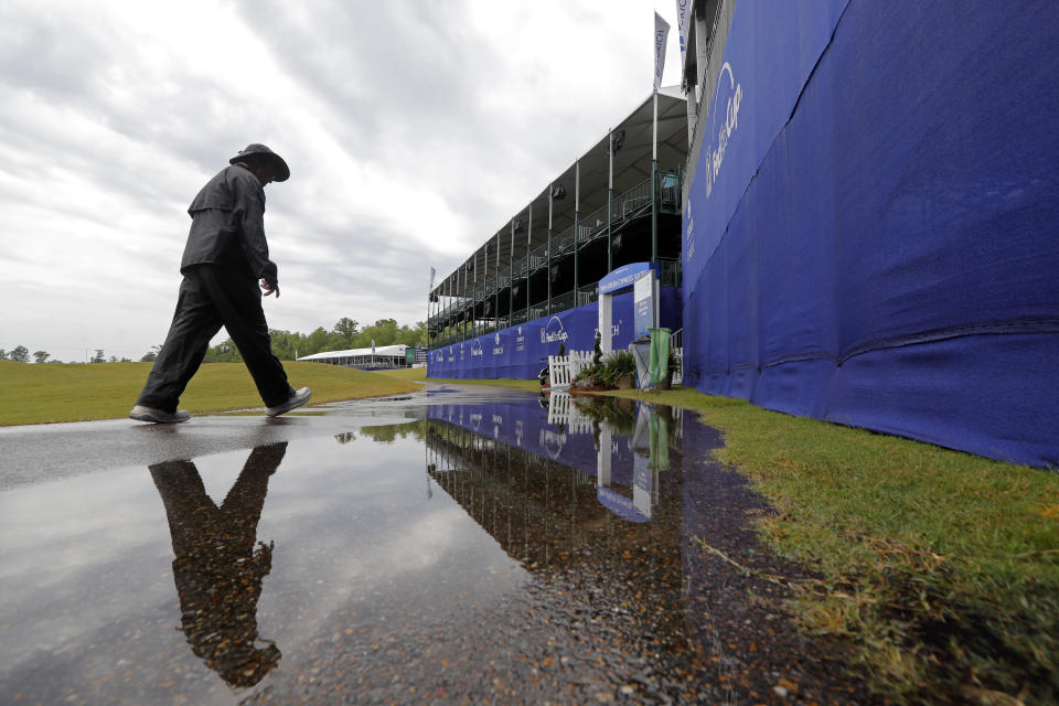 A person walks on the largely empty course during a weather delay for the first round of the PGA Zurich Classic golf tournament at TPC Louisiana in Avondale, La., Thursday, April 25, 2019. (AP Photo/Gerald Herbert)