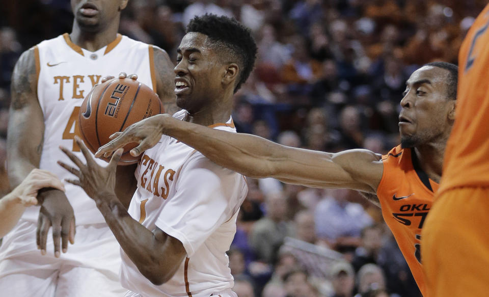 Texas' Isaiah Taylor (1) tries to protect the ball from Oklahoma State's Markel Brown during the first half on an NCAA college basketball game, Tuesday, Feb. 11, 2014, in Austin, Texas. (AP Photo/Eric Gay)