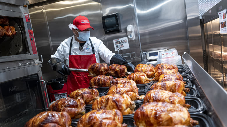 Costco rotisserie chickens being prepared