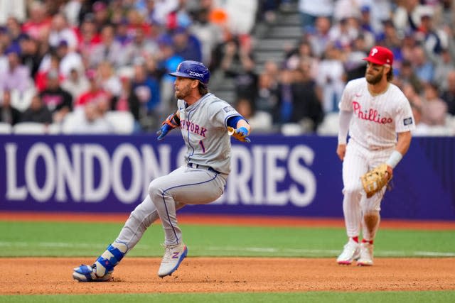 New York Mets’ Jeff McNeil applies the breaks near first base