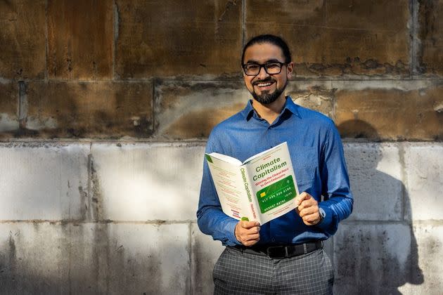 Bloomberg reporter Akshat Rathi poses with his debut book 