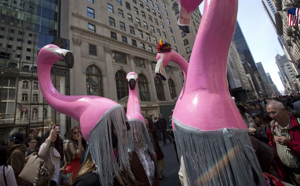 People wear pink flamingo hats as they attend the annual Easter Bonnet Parade in New York April 20, 2014. REUTERS/Carlo Allegri (UNITED STATES - Tags: ANIMALS SOCIETY)