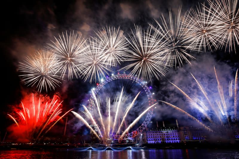 Fireworks explode over the London Eye wheel during New Year celebrations in central London