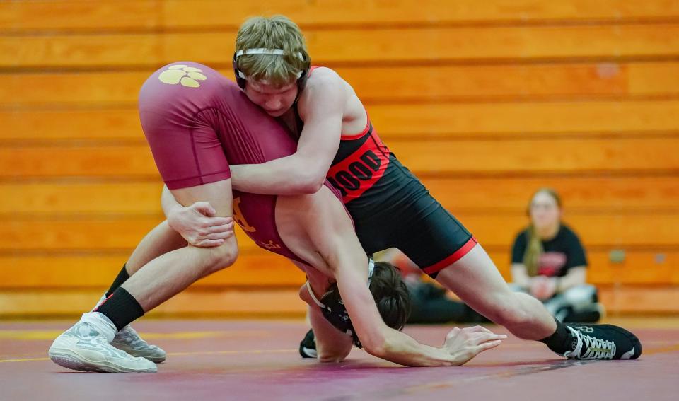 Edgewood's Cayleb Sides (right) wrestles against Bloomington North’s Cas Crevello in the 126-pound match during their dual match at North on Tuesday, Jan. 9, 2024.