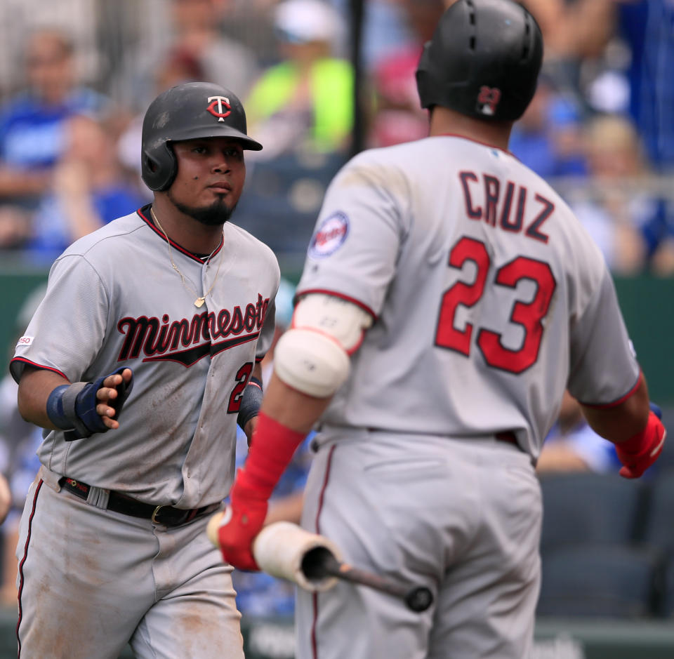 Minnesota Twins' Luis Arraez (2) is congratulated by teammate Nelson Cruz (23) after scoring in the 10th inning of a baseball game against the Kansas City Royals at Kauffman Stadium in Kansas City, Mo., Saturday, June 22, 2019. (AP Photo/Orlin Wagner)