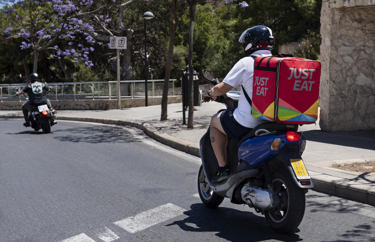 SPAIN - 2019/06/20: Online food order and delivery service company, Just Eat motorbike courier seen in Spain. (Photo by Miguel Candela/SOPA Images/LightRocket via Getty Images)