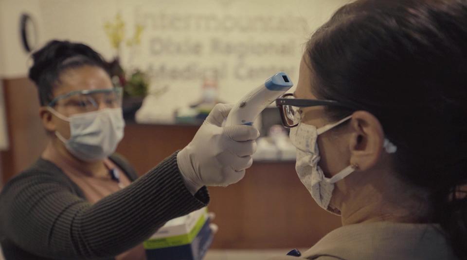 Employees at St. George Regional Hospital are checked for masks and temperatures on their way into work.