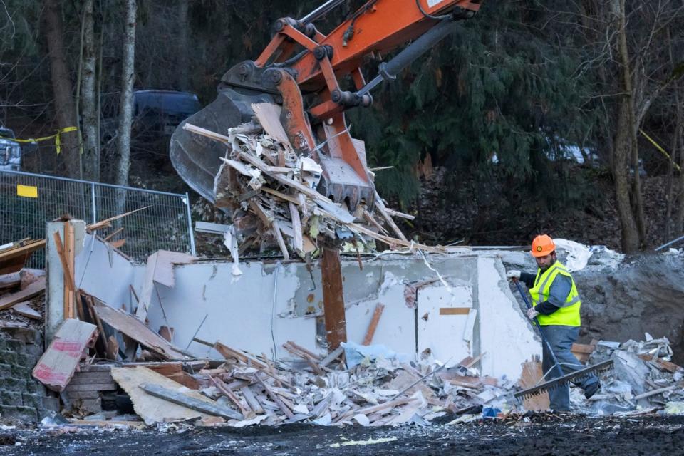 A worker rakes debris during a break in using heavy equipment to demolish the house where four University of Idaho students were killed in 2022, Thursday, Dec. 28, 2023, in Moscow, Idaho ( AP)