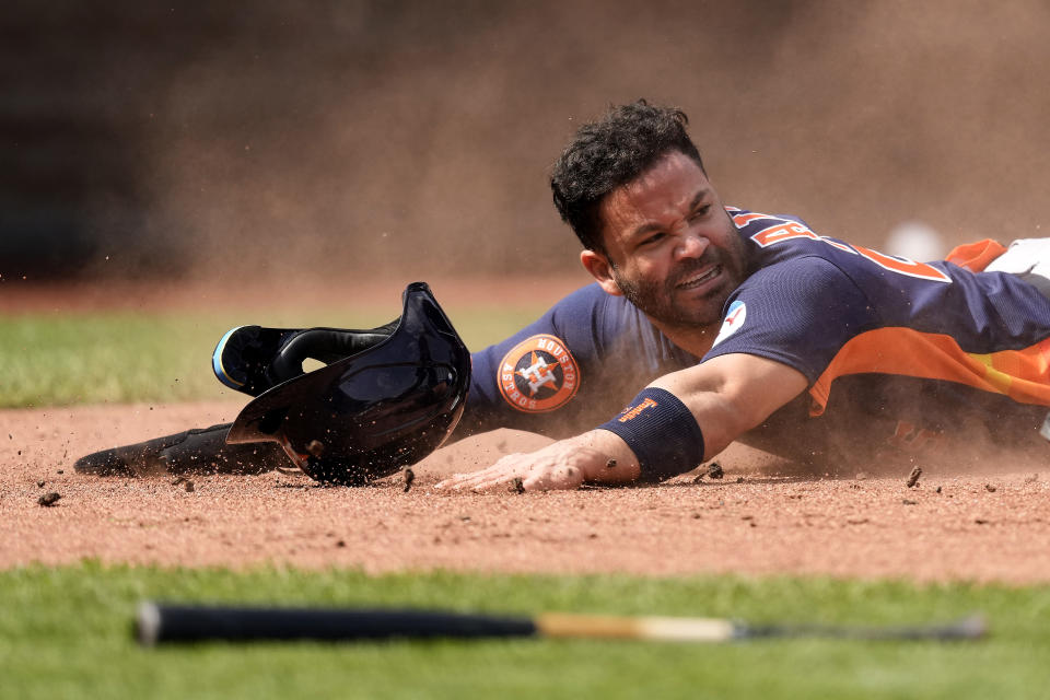 Houston Astros' Jose Altuve slides home to score on a sacrifice fly hit by Jose Abreu during the third inning of a baseball game against the Kansas City Royals Sunday, Sept. 17, 2023, in Kansas City, Mo. (AP Photo/Charlie Riedel)