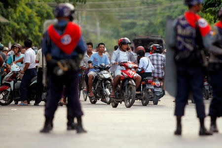 FILE PHOTO: Policemen stand guard in a Muslim neighbourhood in Mandalay July 4, 2014. REUTERS/Soe Zeya Tun/File Photo